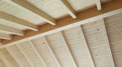 offener Dachstuhl mit weiß lasierter Holzkonstruktion